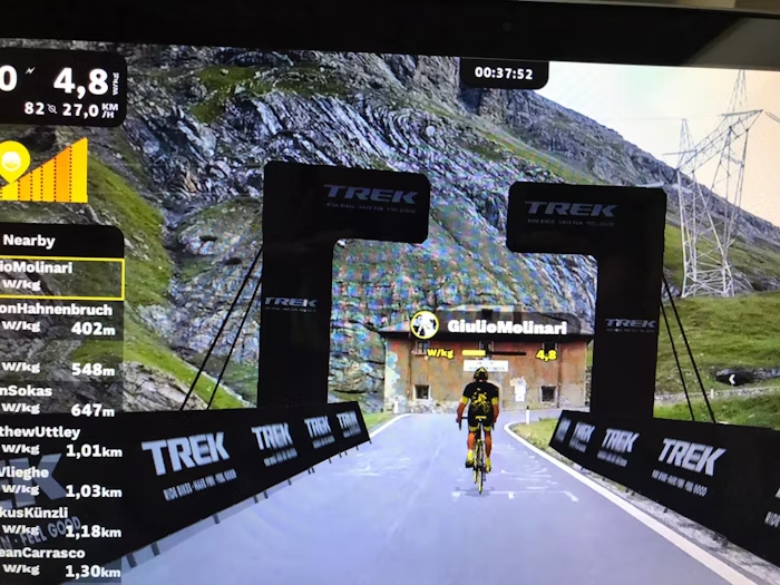 Cyclist Approaching Trek Branded Arch in Virtual Cycling Event