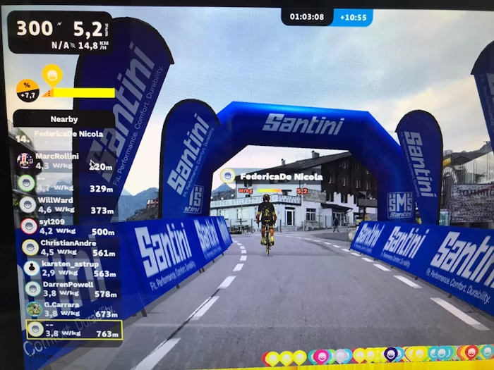 Cyclist Passing Under Santini Branded Arch in Virtual Cycling Event